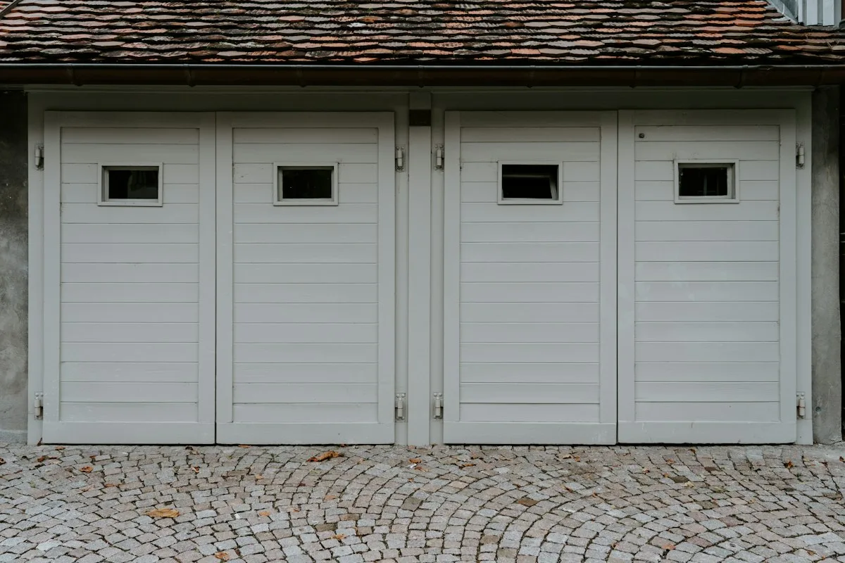 Closed white residential garage door on a house