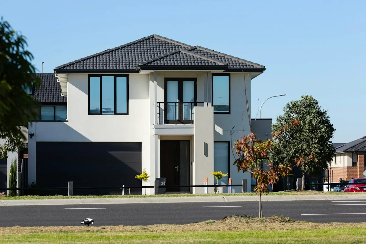 Modern two-story house with a dark garage door and large windows